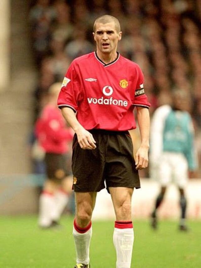 Roy Keane commanding the midfield during a match.