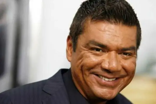 George Lopez smiling at a public event, highlighting his net worth and career success in comedy and television.